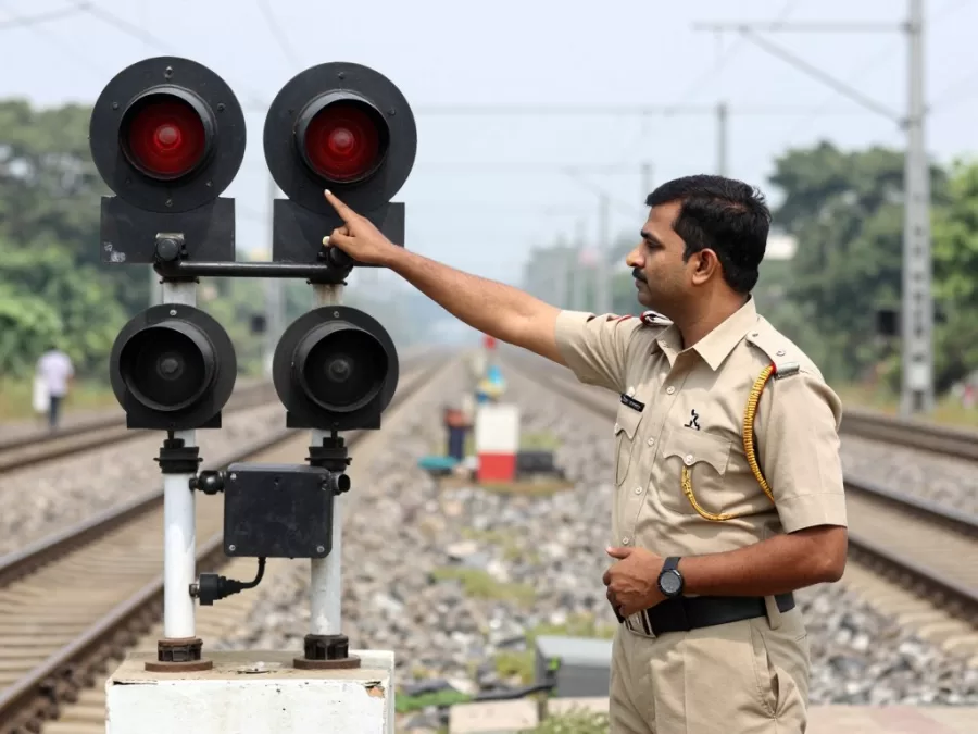 Assistant pointsman managing railway signal operations at junction